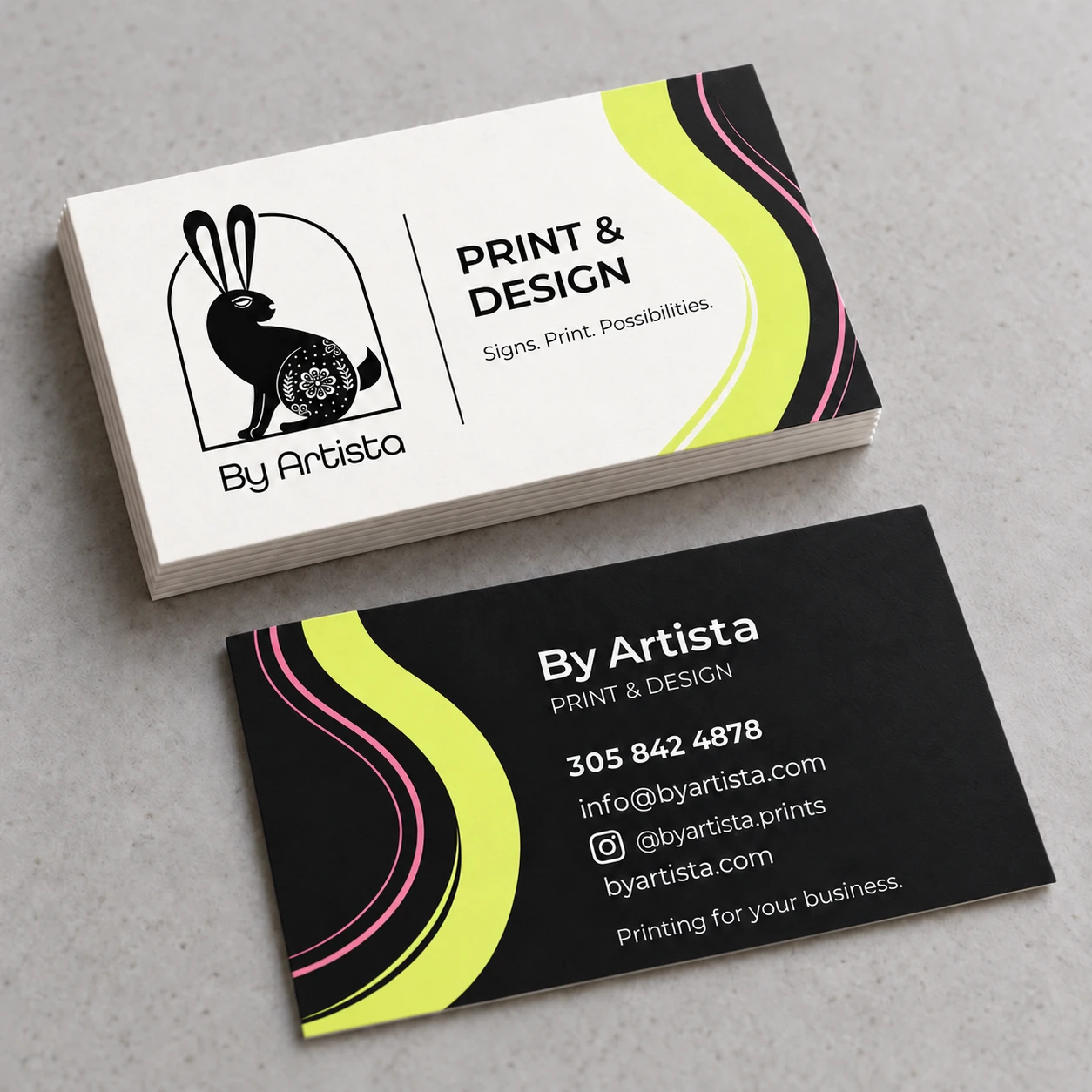 By Artista business cards showing the front and back designs